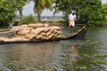 Allepey, Kerala, India Ã¢â¬â March 31, 2015: Indian man transport dwell with rice for boats. backwaters canoe in state Royalty Free Stock Photo